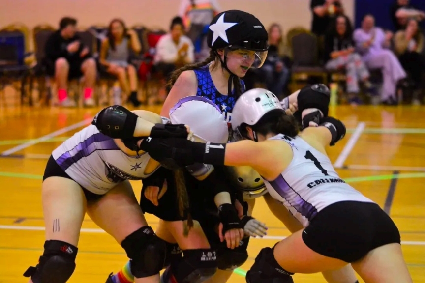 Nor'east Uprising junior roller derby skaters battling in a pack during a bout