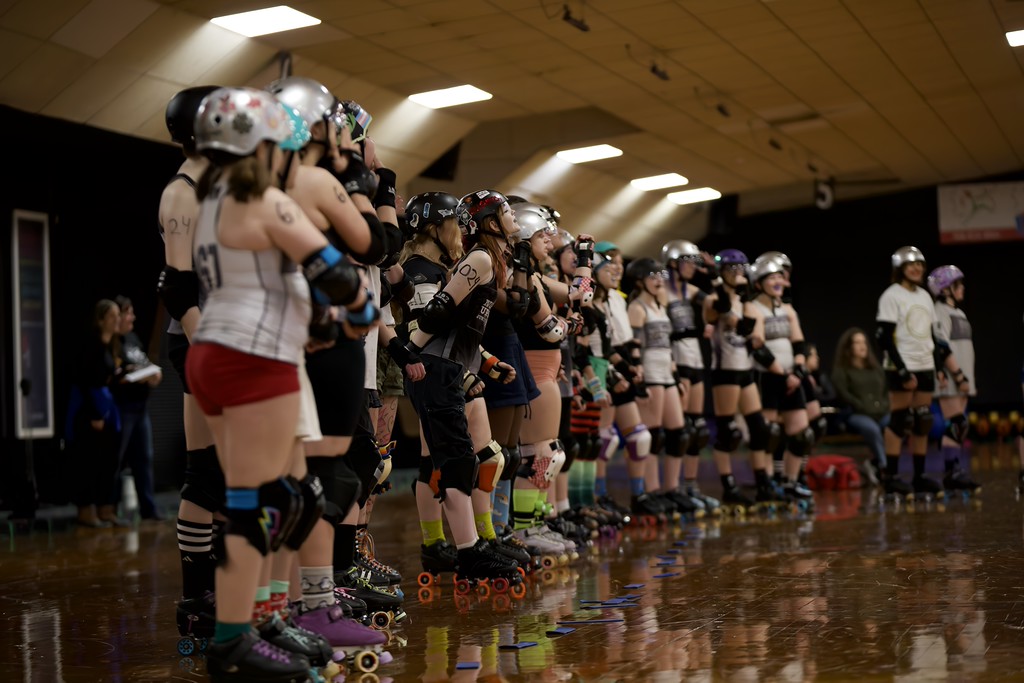 Nor'east Uprising junior roller derby team lined up together before a bout